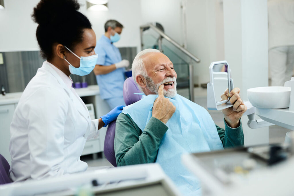 elderly man receiving dental treatment from a professional under canadian dental care plan