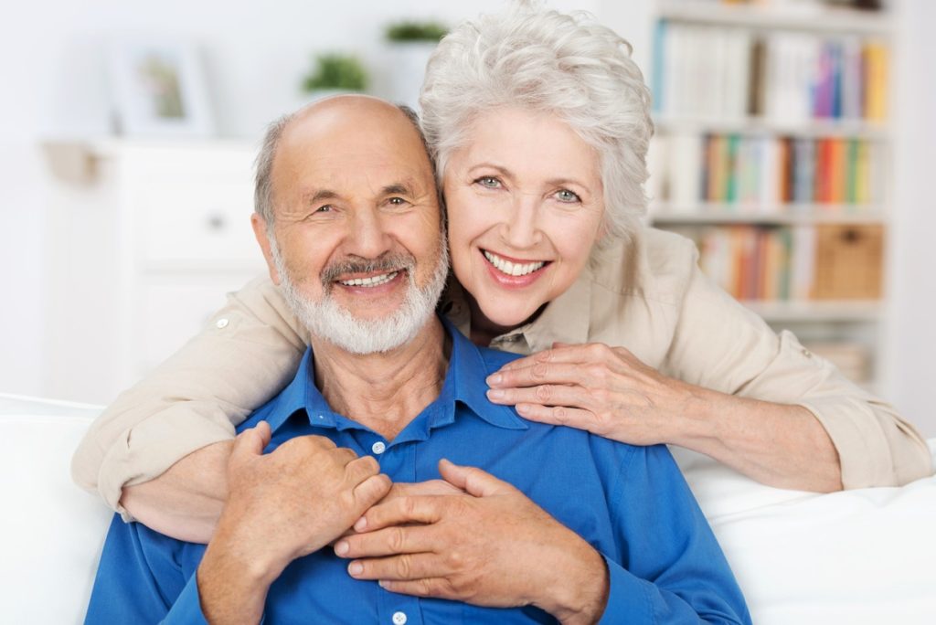 smiling seniors couple benefiting from canadian dental care plan coverage